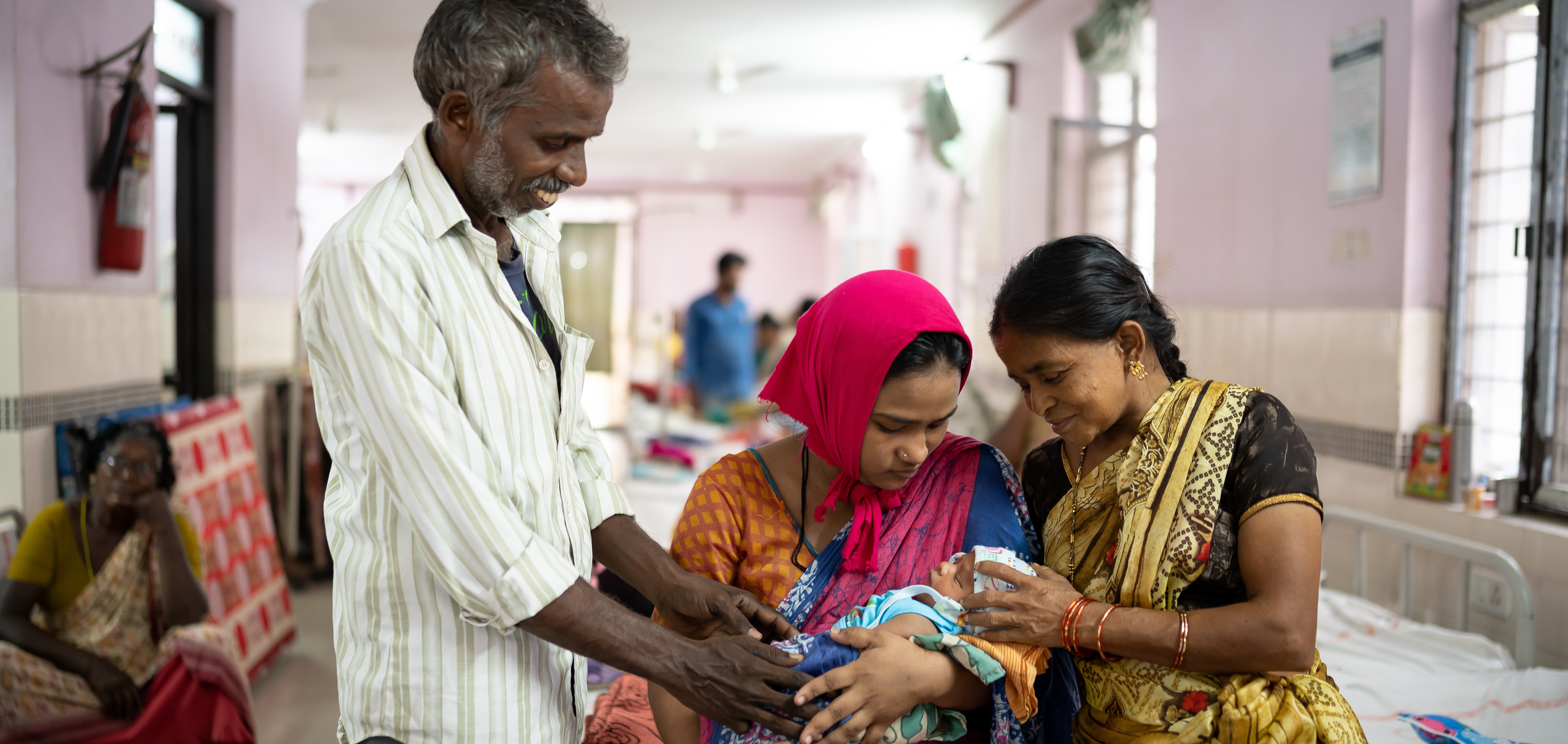 A family with a newborn in the maternity wing of a hospital in Vijayawada